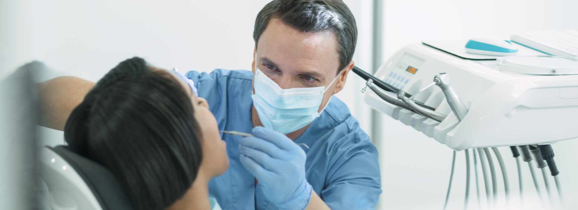 A woman is having dental extraction.